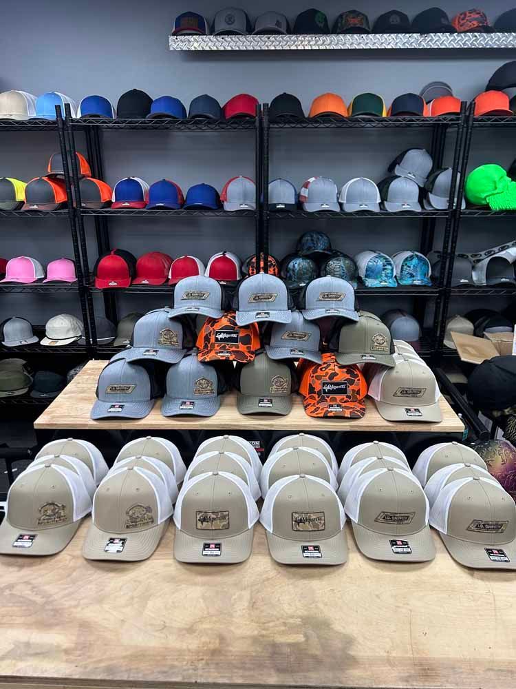 A bunch of hats are sitting on a table in a store.