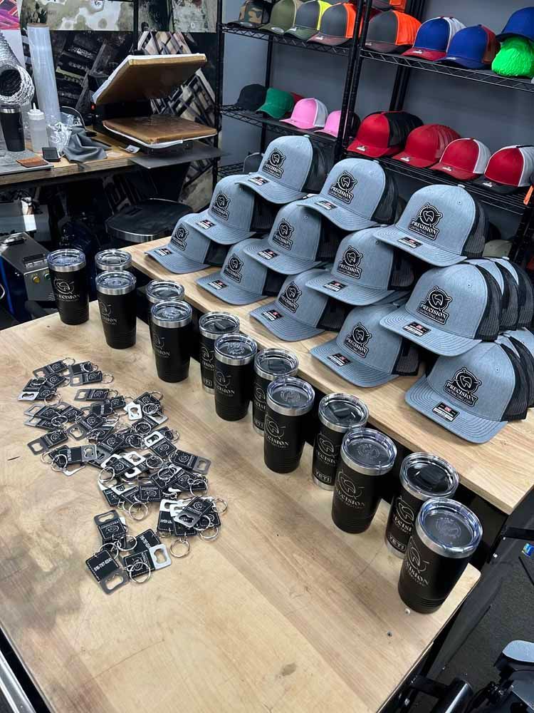 A table filled with lots of hats and tumblers.