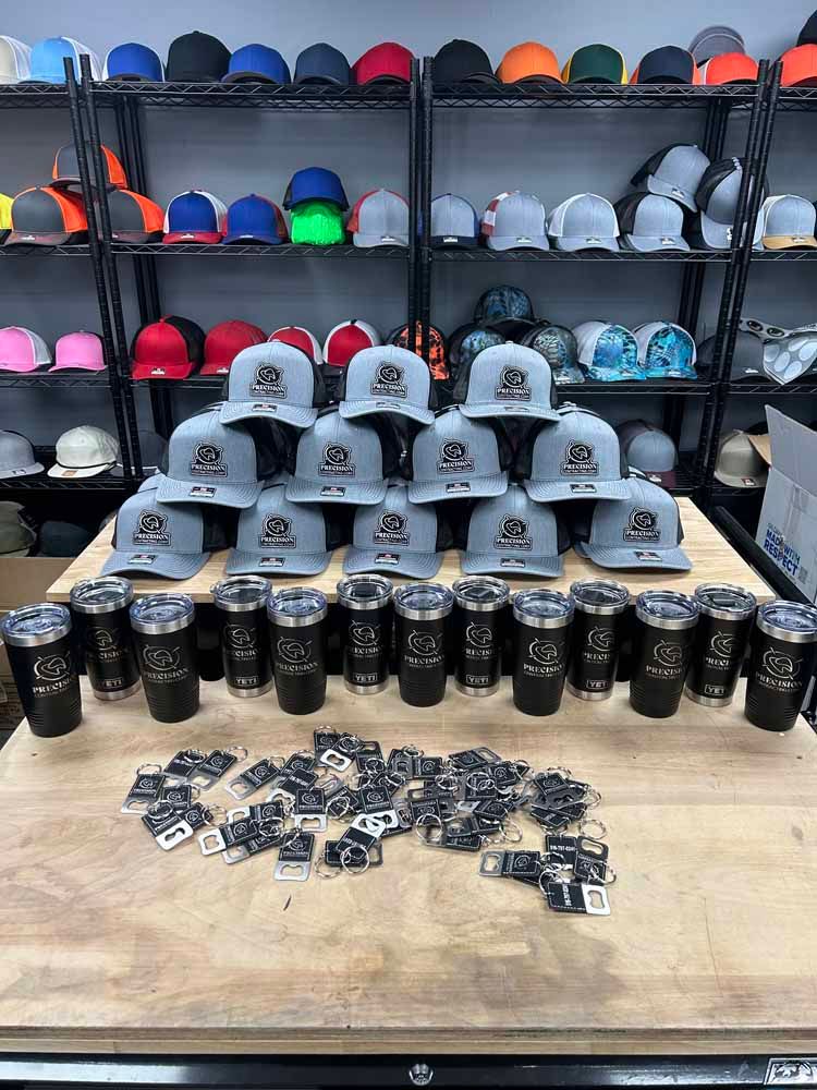 A bunch of hats and tumblers are sitting on a table in a store.