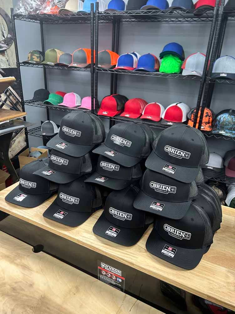 A bunch of hats are sitting on a table in a store.
