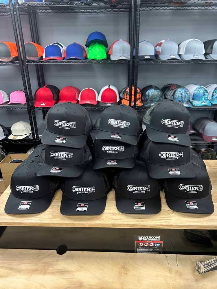 A bunch of hats are stacked on top of each other on a table in a store.