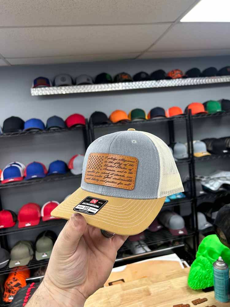 A person is holding a hat in their hand in a store.