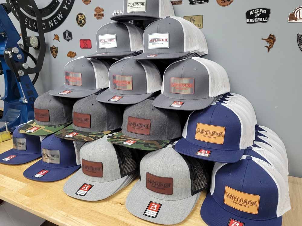 A bunch of hats are stacked on top of each other on a table.