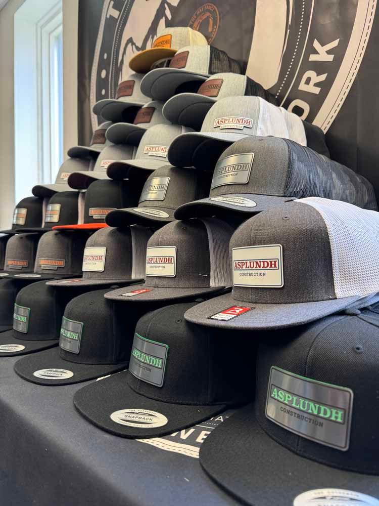 A bunch of hats are stacked on top of each other on a table.