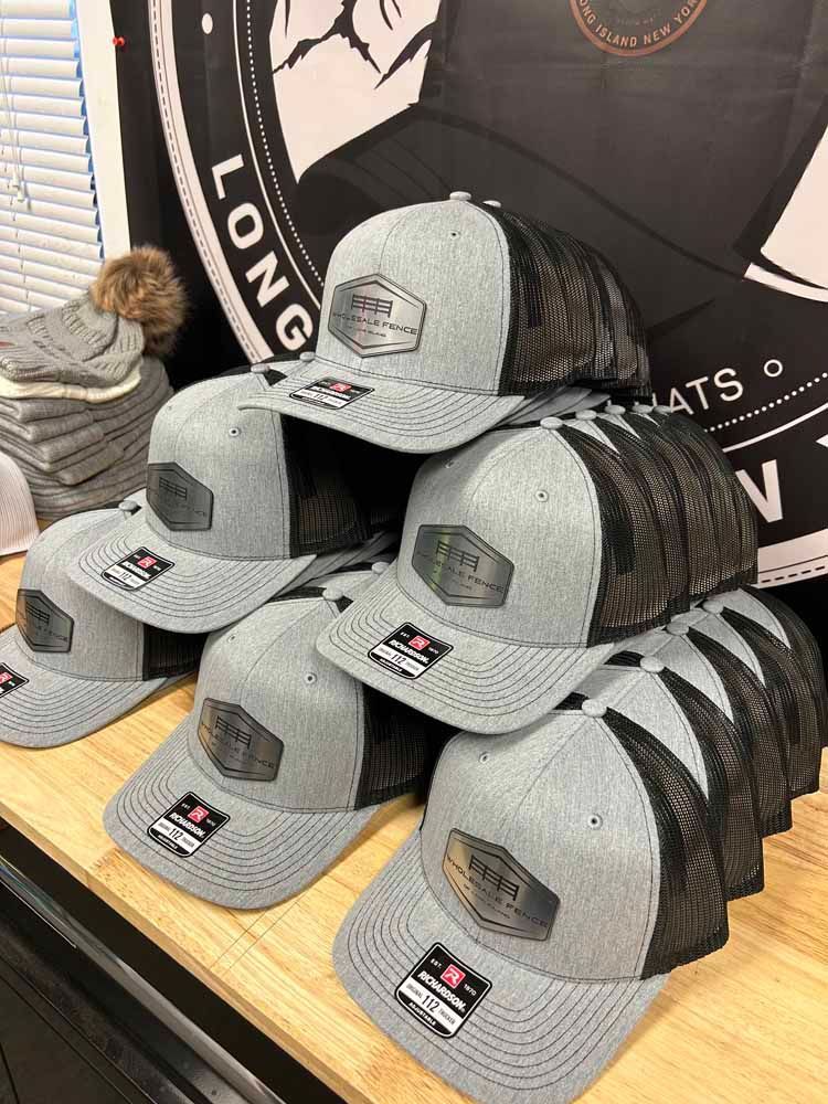 A bunch of hats are stacked on top of each other on a table.