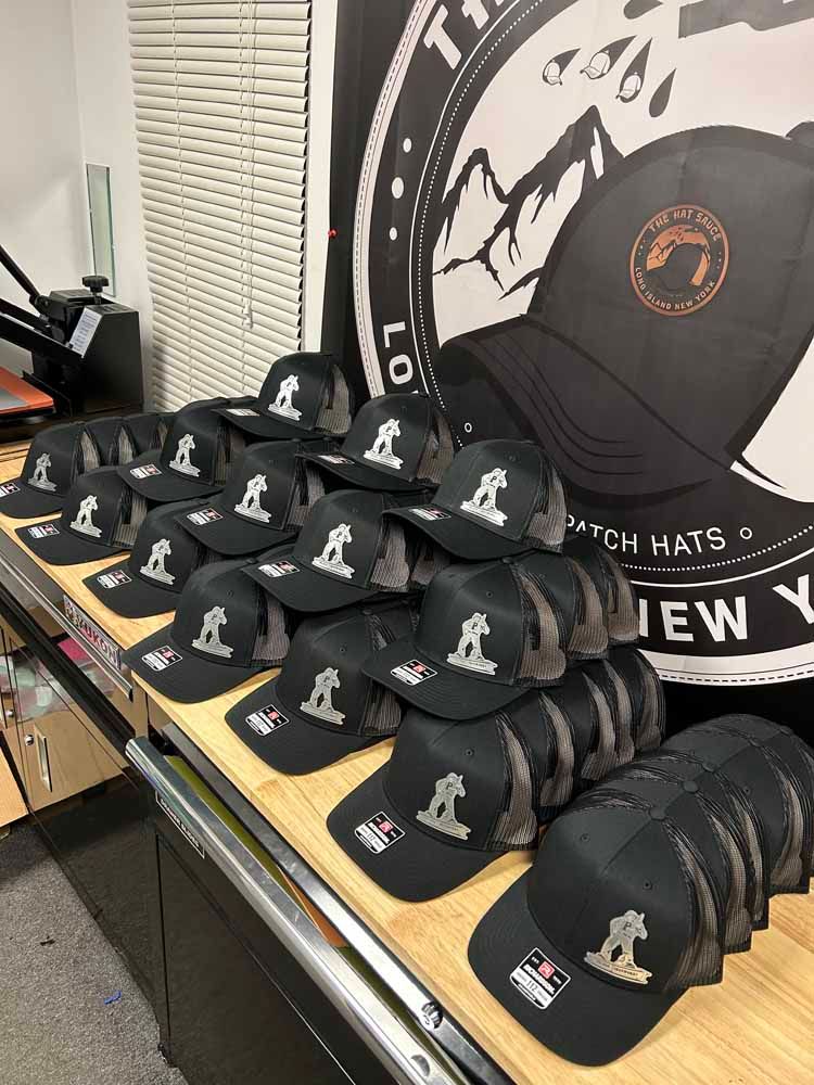 A bunch of hats are stacked on top of each other on a table.
