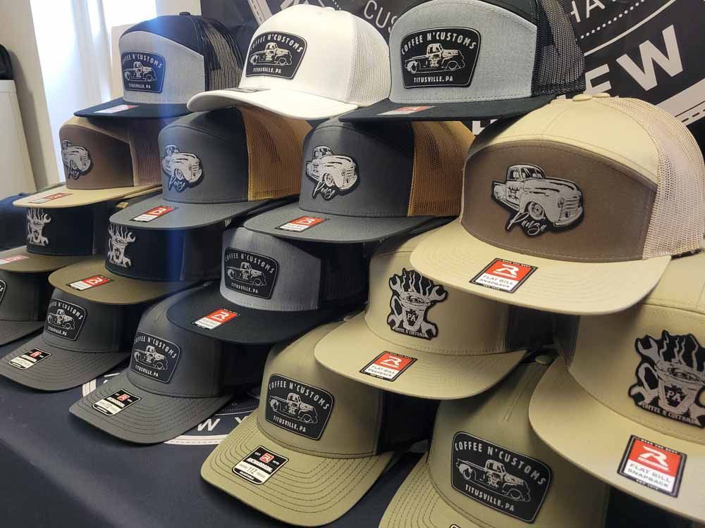 A bunch of hats are stacked on top of each other on a table.