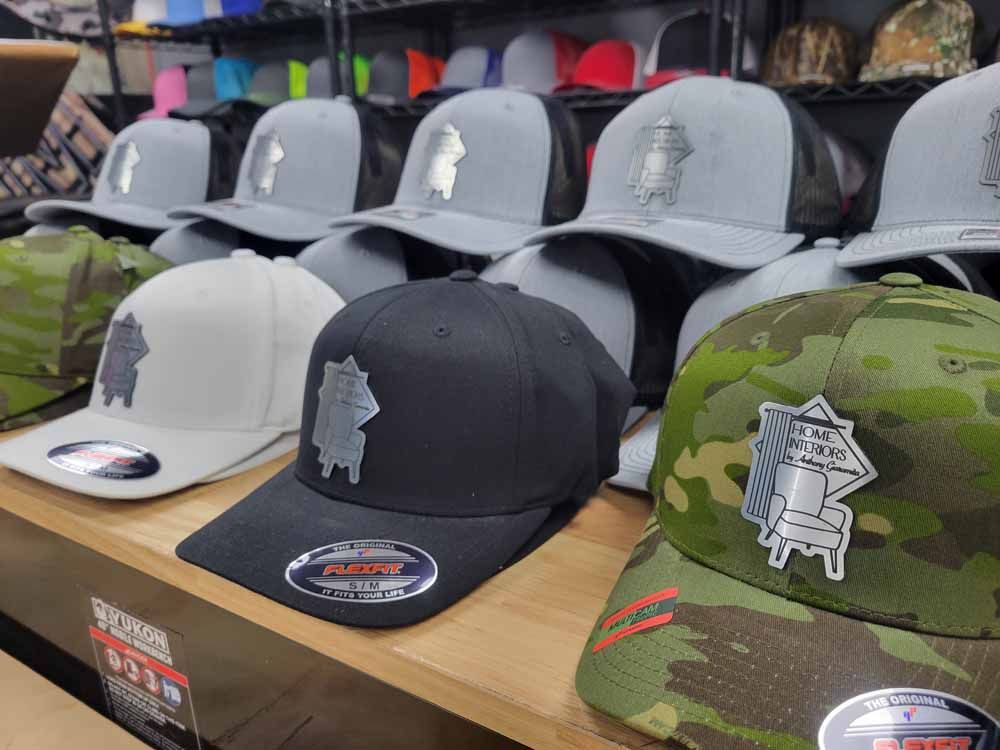 A row of hats are lined up on a shelf in a store.