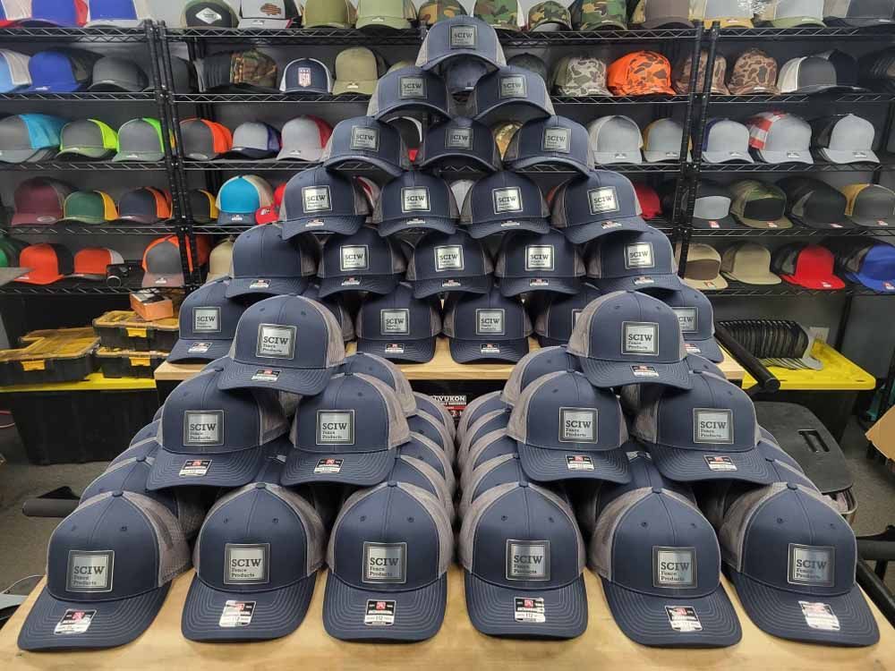 A bunch of hats are stacked on top of each other on a table.