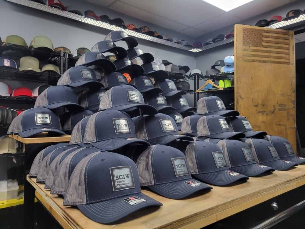 A bunch of hats are stacked on top of each other on a table in a store.