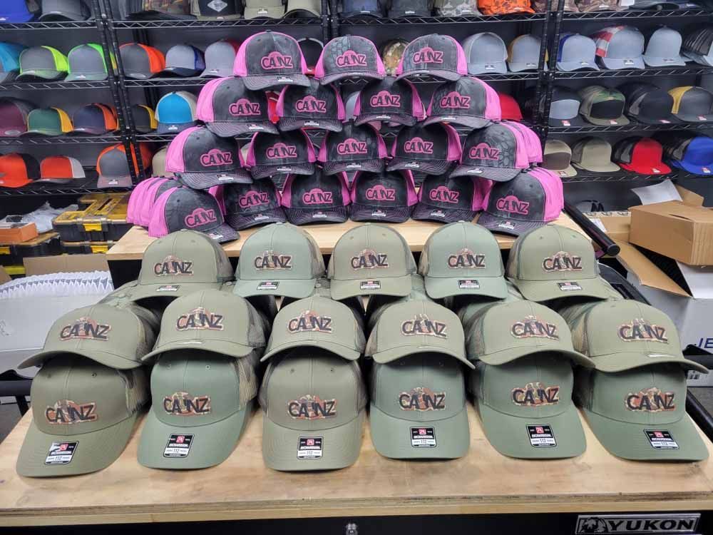A bunch of hats are sitting on a table in a store.