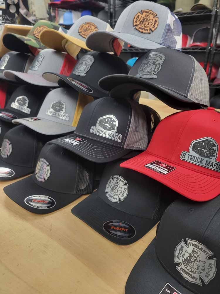 A bunch of hats are stacked on top of each other on a table.