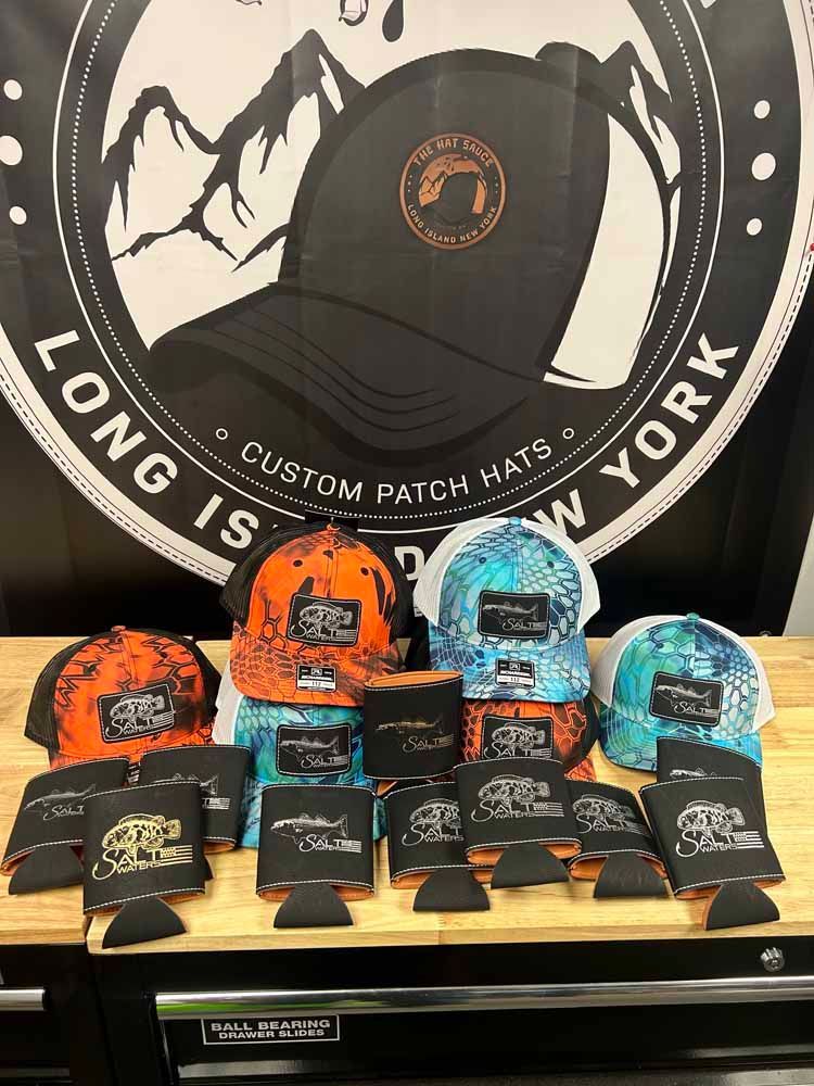 A bunch of hats are sitting on a wooden table.