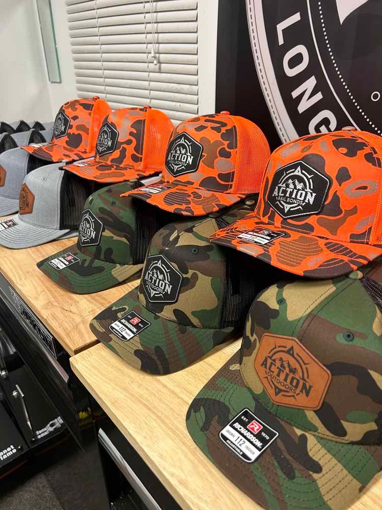 A bunch of hats are sitting on top of a wooden table.