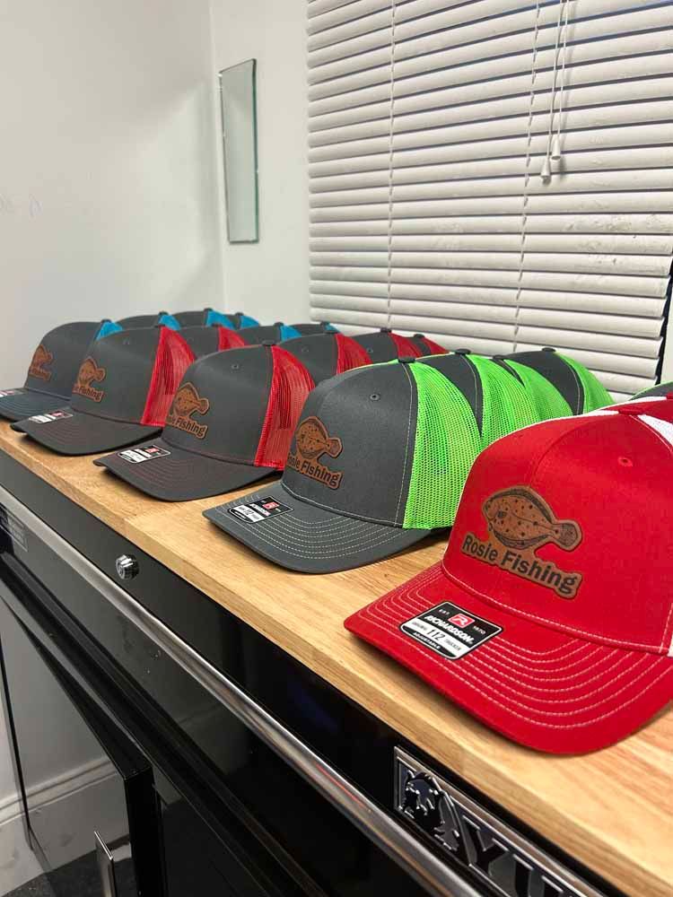 A row of hats sitting on top of a wooden shelf.