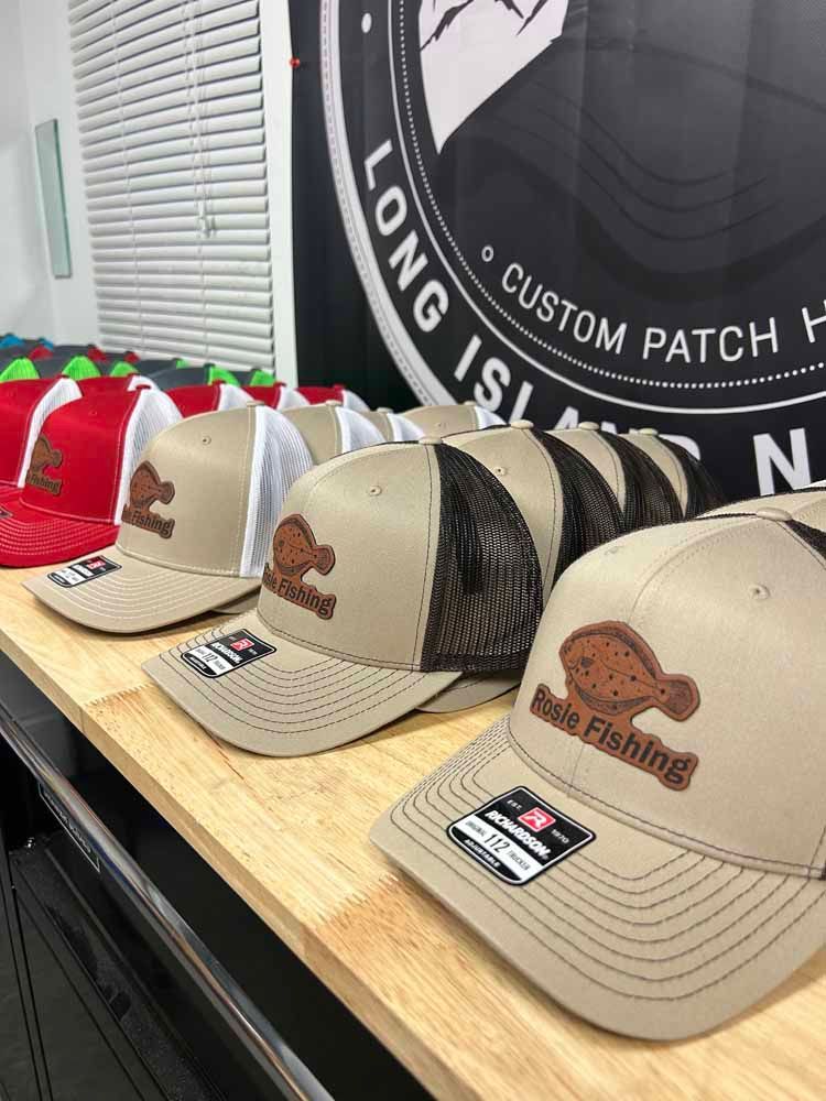 A bunch of hats are sitting on a wooden table.