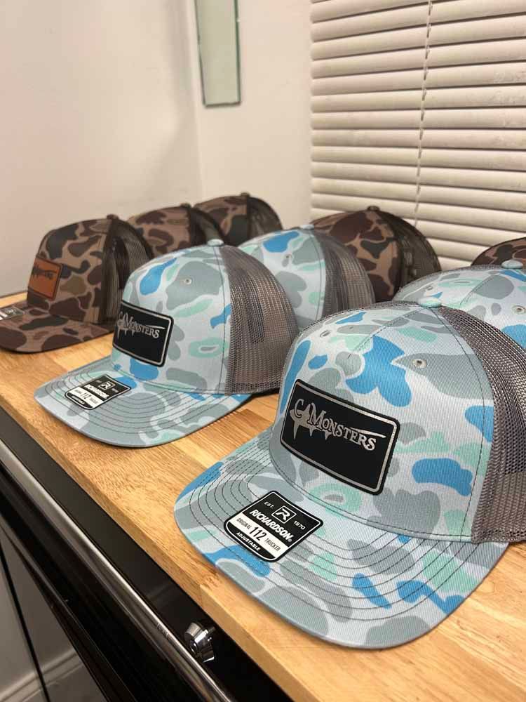 A row of hats sitting on top of a wooden table.
