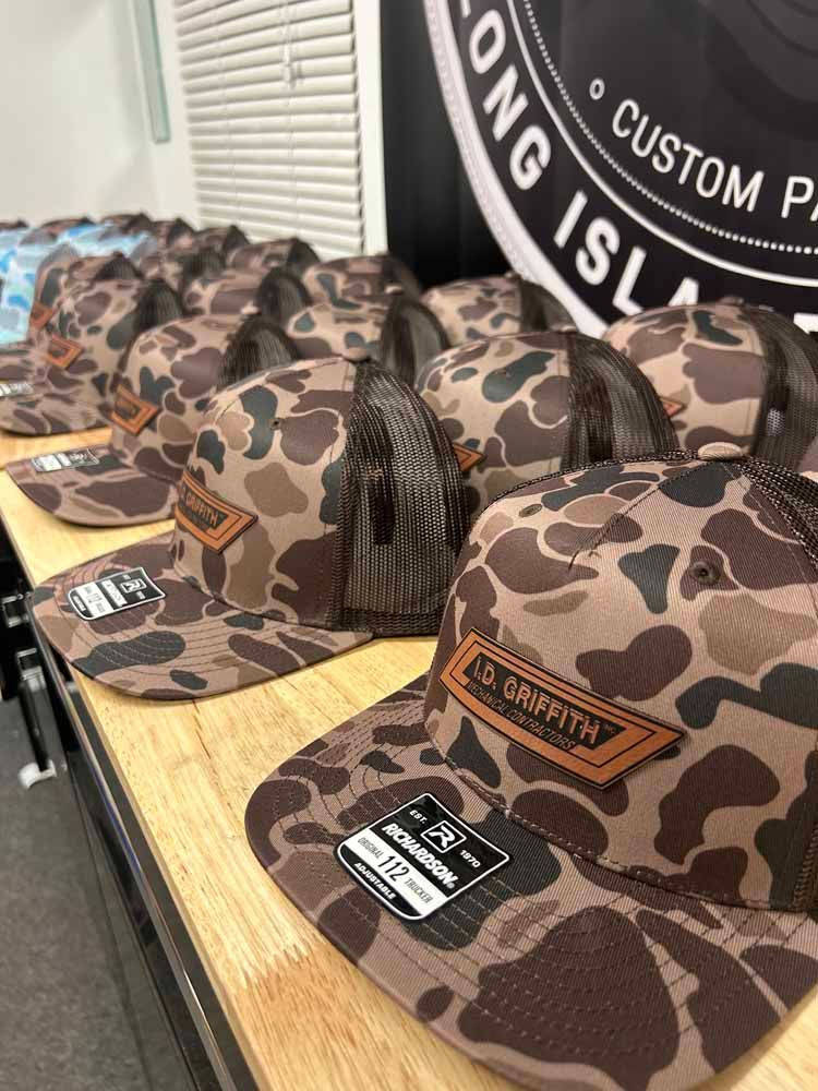 A row of hats sitting on top of a wooden table.