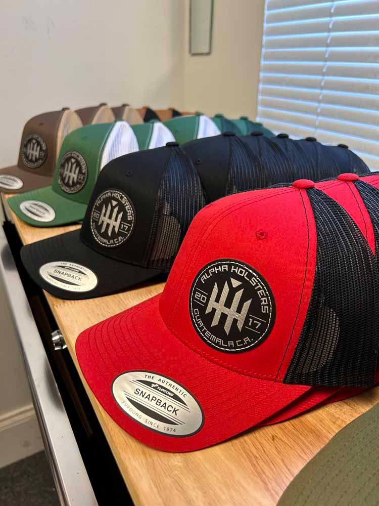 A row of hats sitting on top of a wooden table.