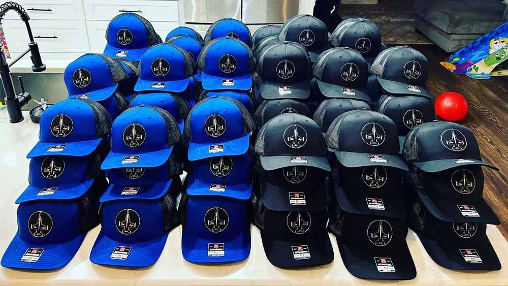 A bunch of hats are stacked on top of each other on a table.