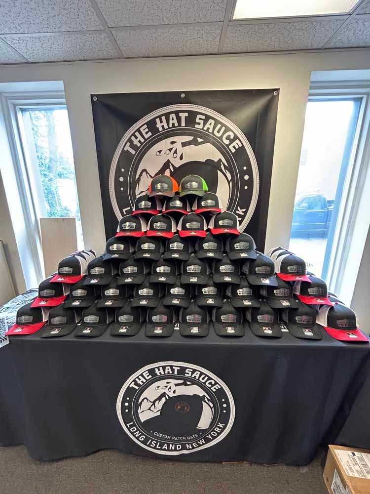 A bunch of hats are stacked on top of each other on a table.