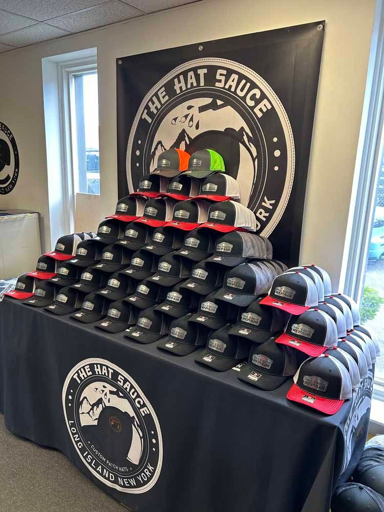 A bunch of hats are stacked on top of each other on a table.