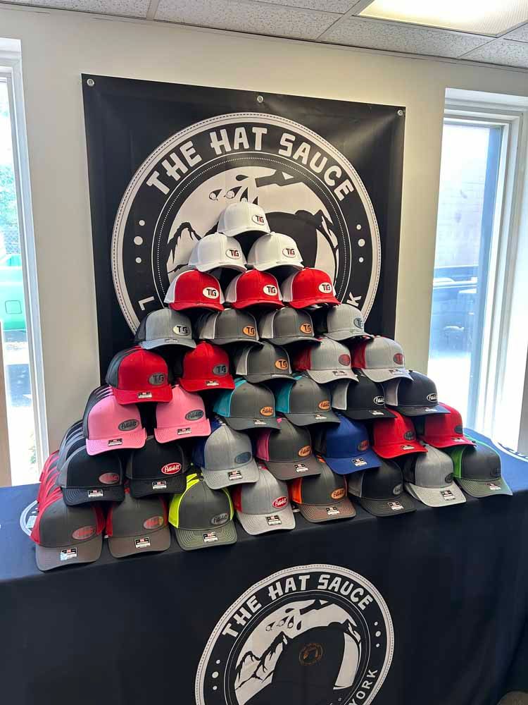 A bunch of hats are stacked on top of each other on a table.