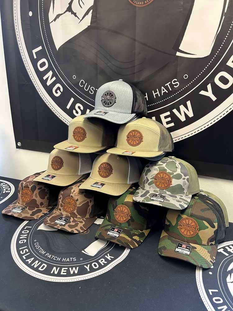 A bunch of hats are stacked on top of each other on a table.