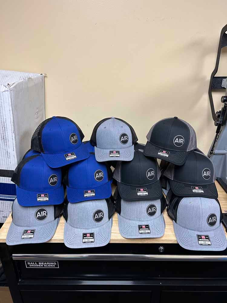 A bunch of hats are stacked on top of each other on a table.