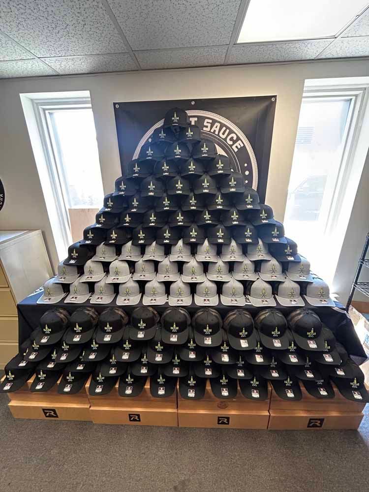 A bunch of hats are stacked on top of each other in a room.