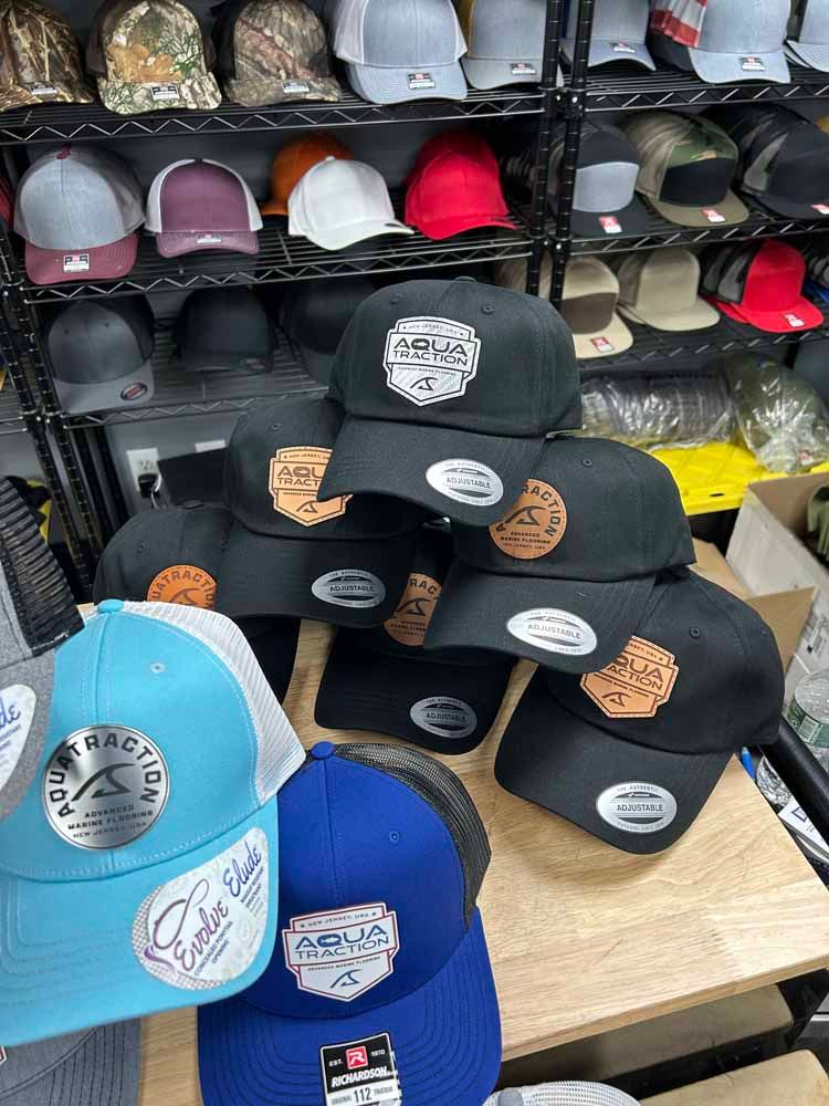 A bunch of hats are stacked on top of each other on a table.