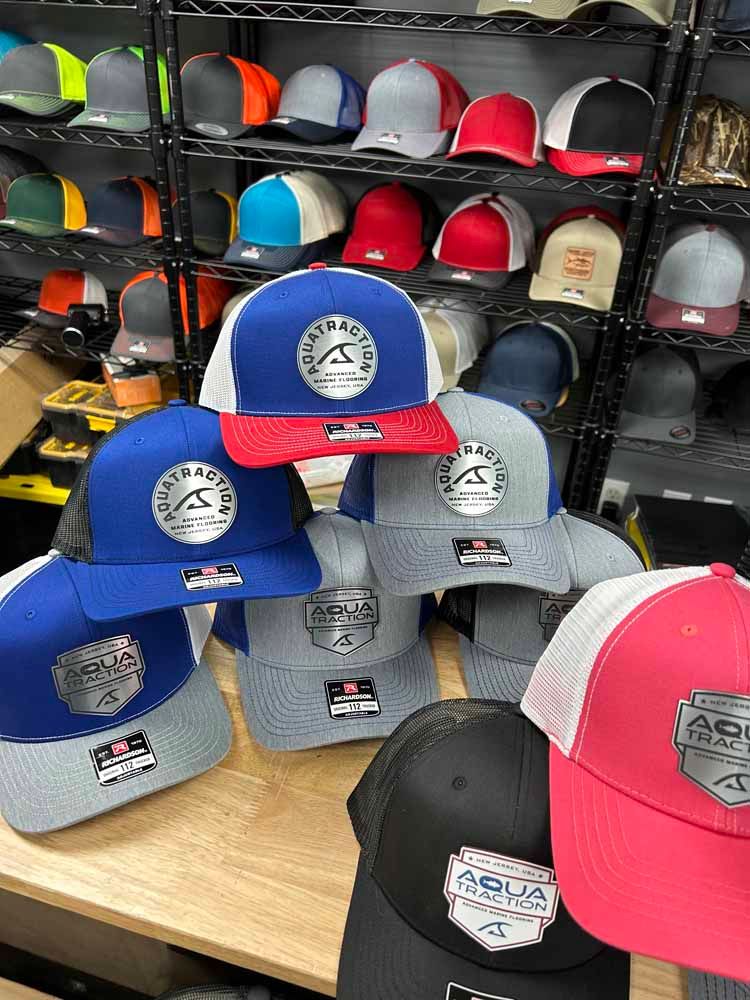 A bunch of hats are stacked on top of each other on a table.