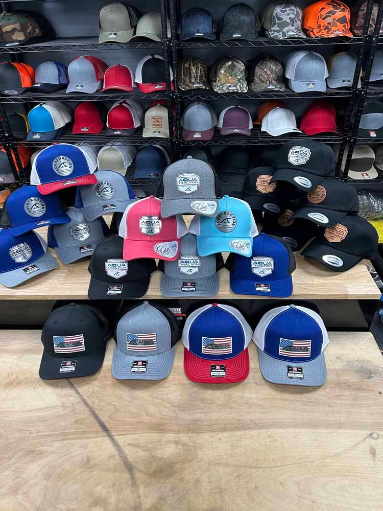 A bunch of hats are stacked on top of each other on a table.