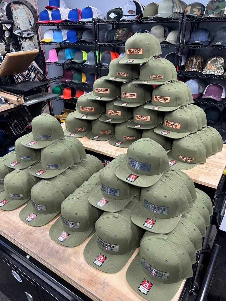 A bunch of hats are stacked on top of each other on a table.