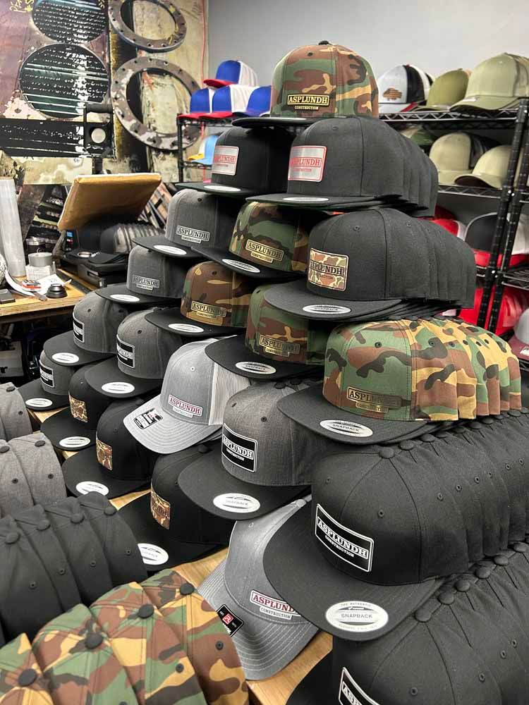 A bunch of hats are stacked on top of each other in a store.