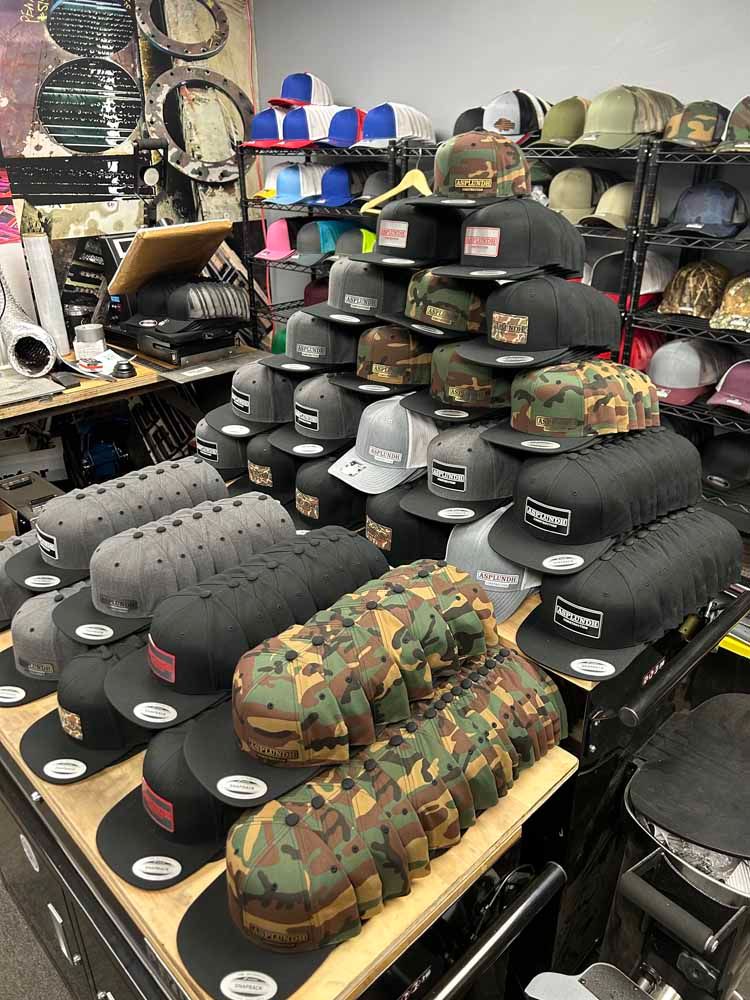 A bunch of hats are stacked on top of each other in a store.