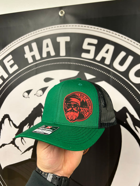 A person is holding a green hat in front of a sign that says the hat sauce