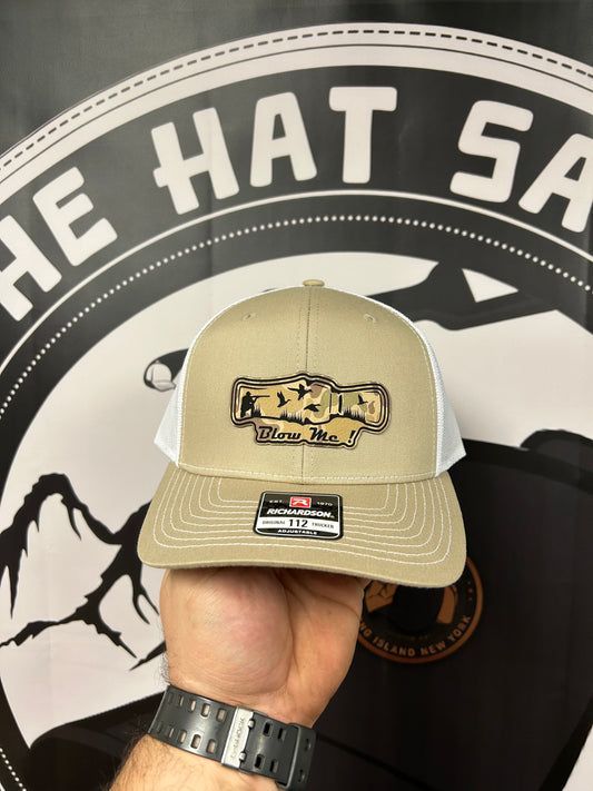 A person is holding a hat in front of a sign that says the hat shop