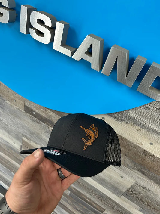 A person is holding a hat in front of a sign that says island