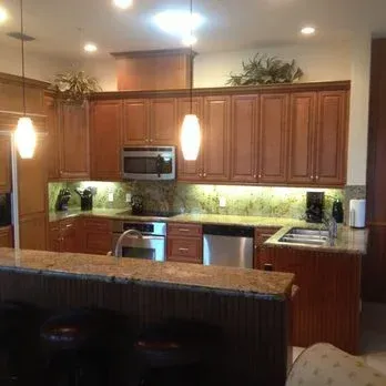 Kitchen with wooden cabinets, granite countertops, and stainless steel appliances.