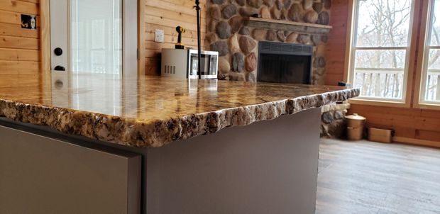 Kitchen with stone countertop and stone fireplace.