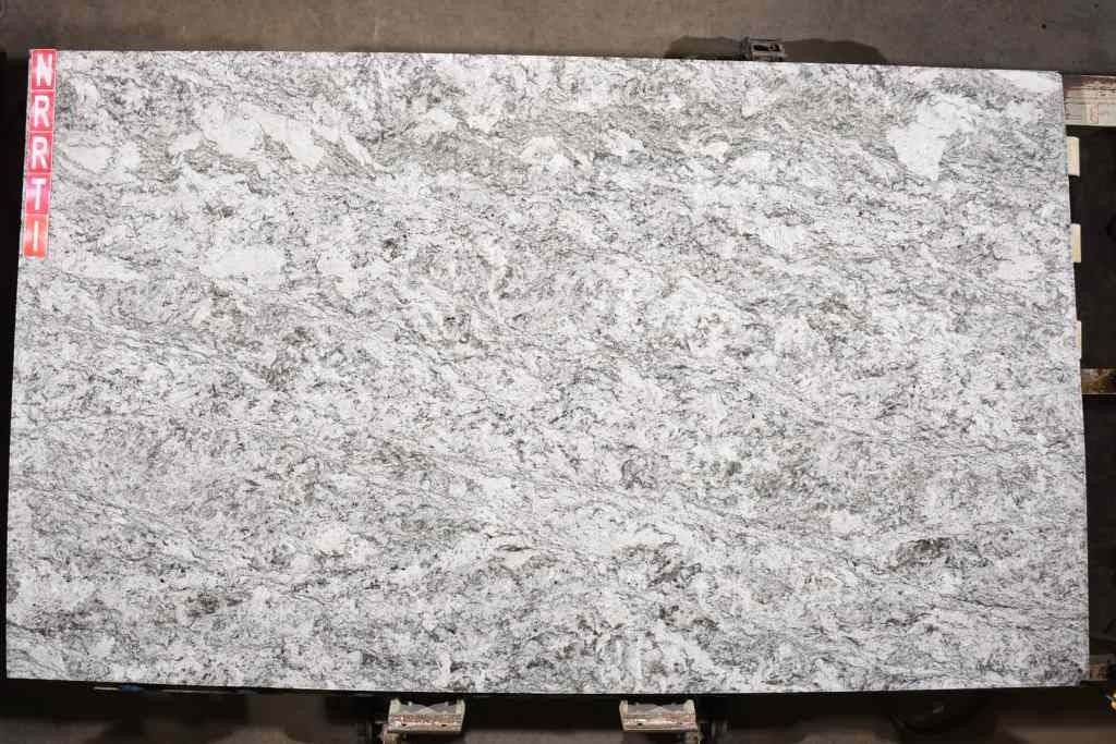 Large rectangular slab of white granite with gray veining.