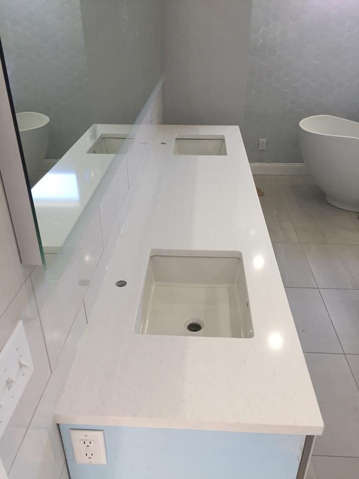White double bathroom vanity with rectangular sinks, blue cabinet, and mirror.