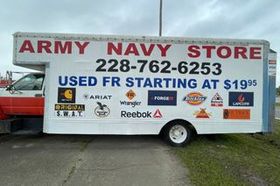 White Army Navy Store trailer with red sign and phone number
