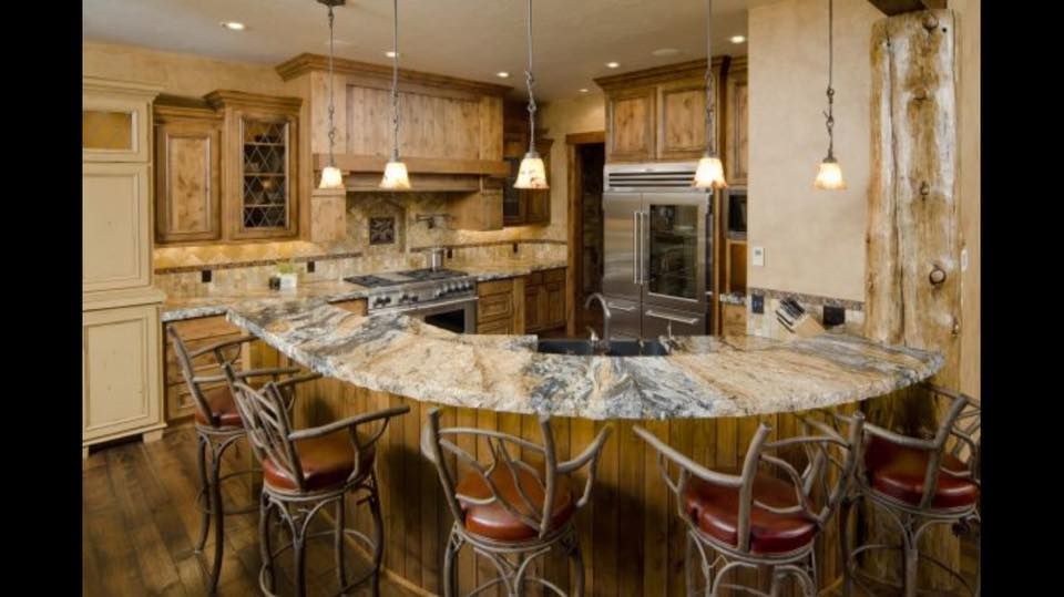 A kitchen with a large island and stools