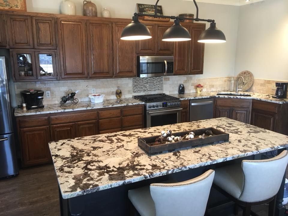 A kitchen with stainless steel appliances and wooden cabinets.