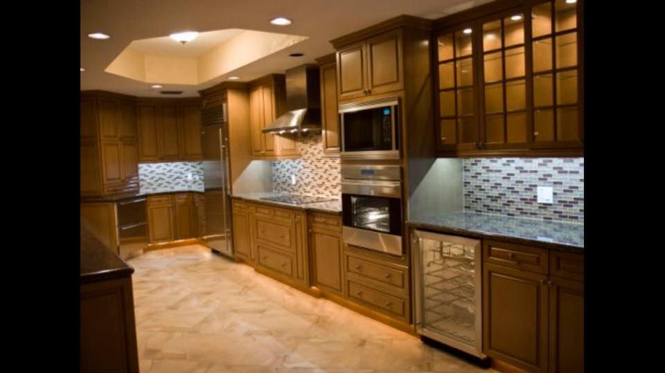 A kitchen with wooden cabinets and stainless steel appliances