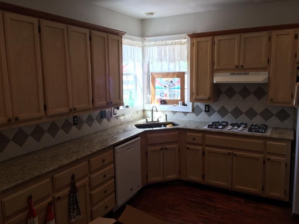 A kitchen with wooden cabinets and granite counter tops