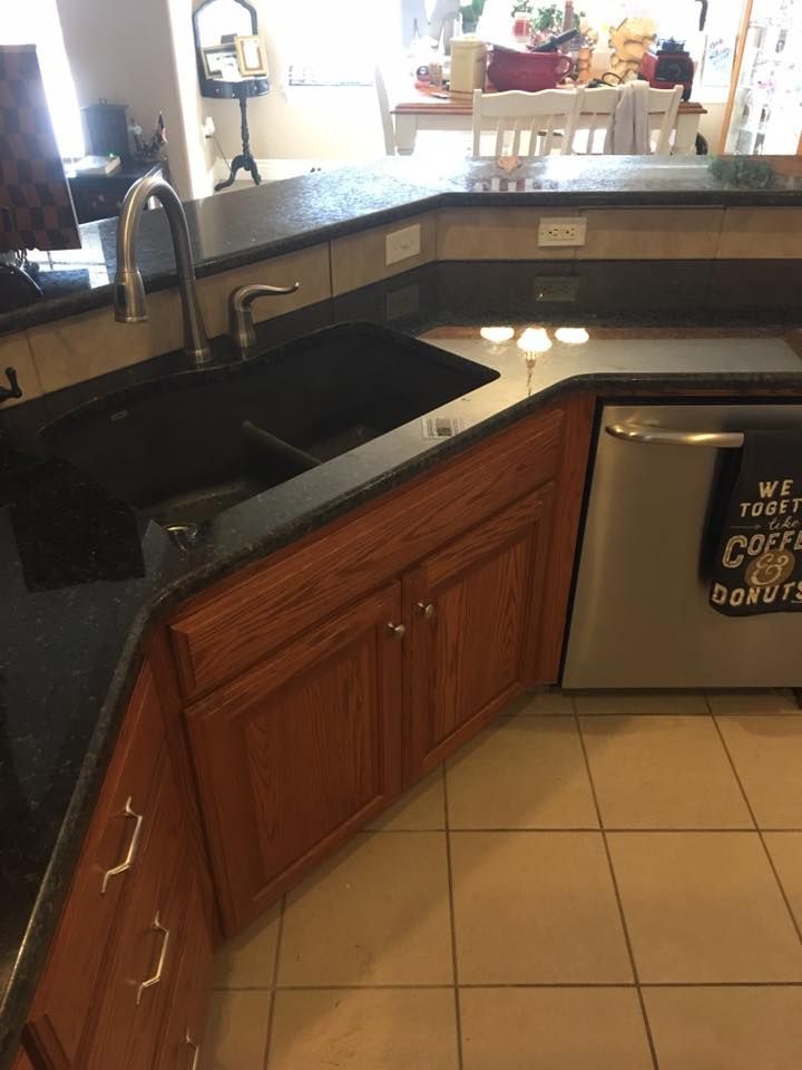 A kitchen with a sink and a dishwasher and a towel that says `` wait until you cook donuts ''.