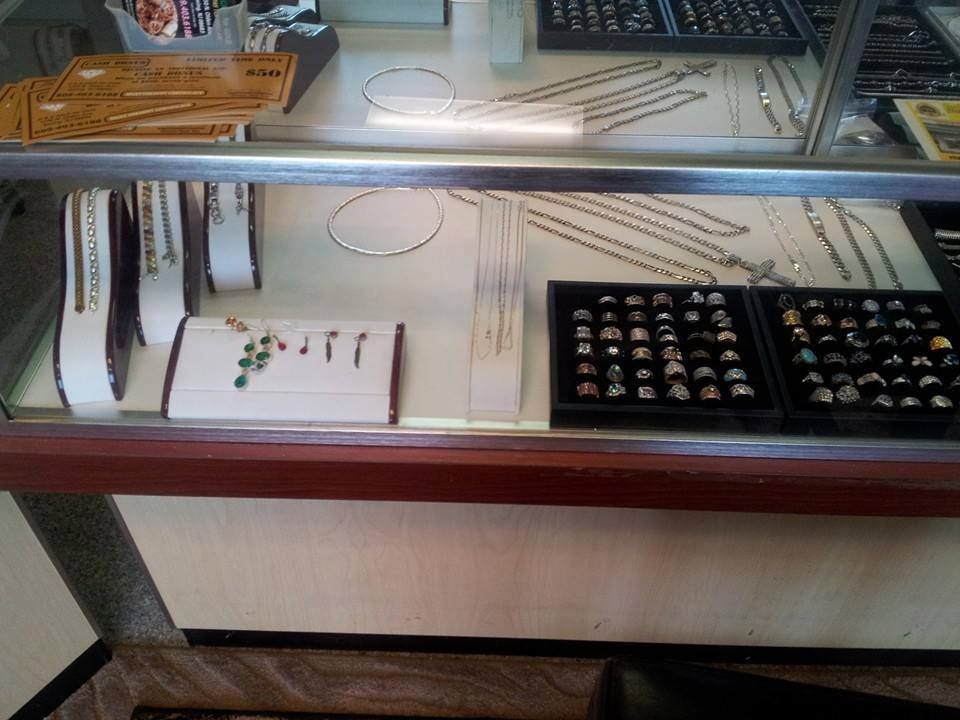 Jewelry display case with necklaces, bracelets, and rings.